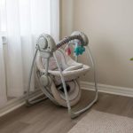 Folded Ingenuity Soothe ‘n Delight baby swing stored neatly in a small apartment corner for space efficiency