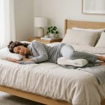 Side sleeper resting comfortably with an ergonomic memory foam knee pillow between legs